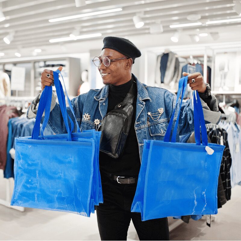 Man holding reusable shopping bags Man holding reusable shopping bags